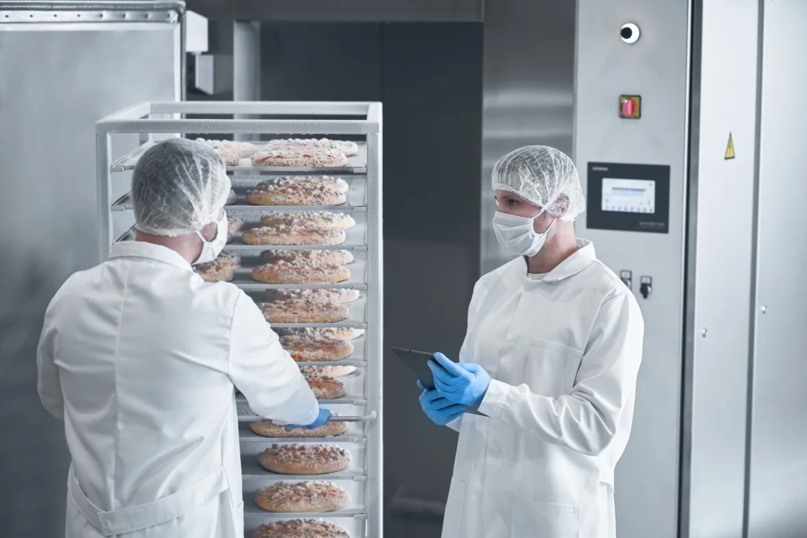 Dohmeyer engineers inspecting food in an industrial cryogenic freezer